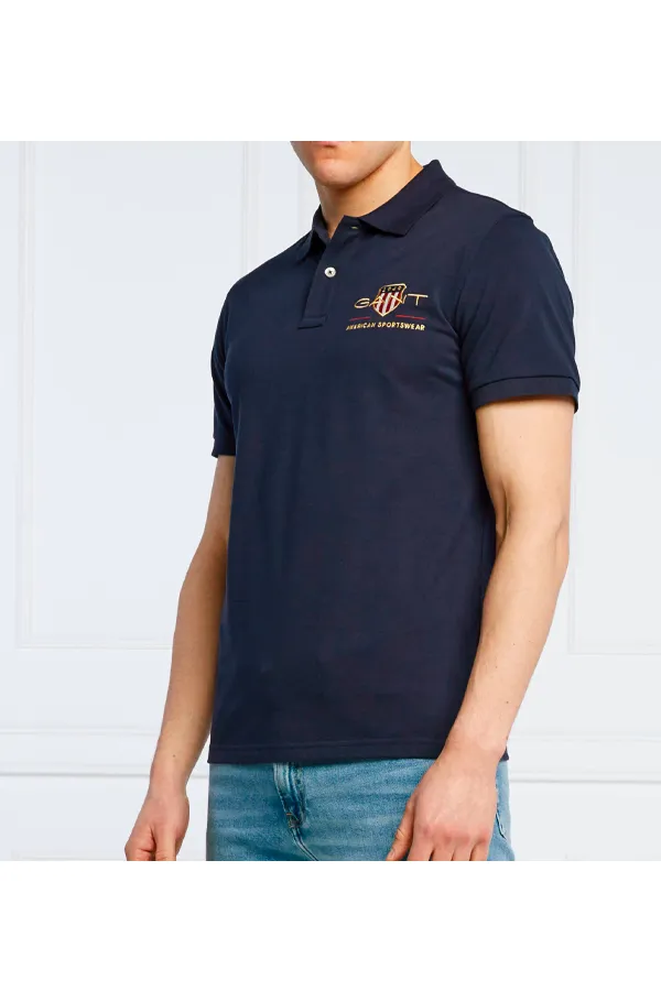 GANT Navy Piqué Polo with Gold Shield Design.