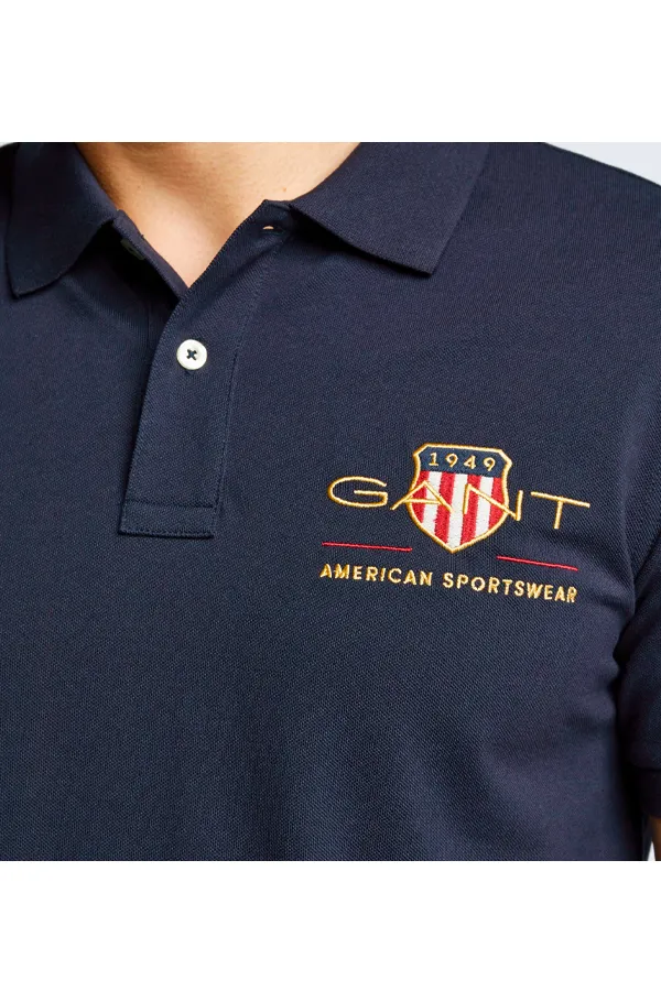 GANT Navy Piqué Polo with Gold Shield Design.